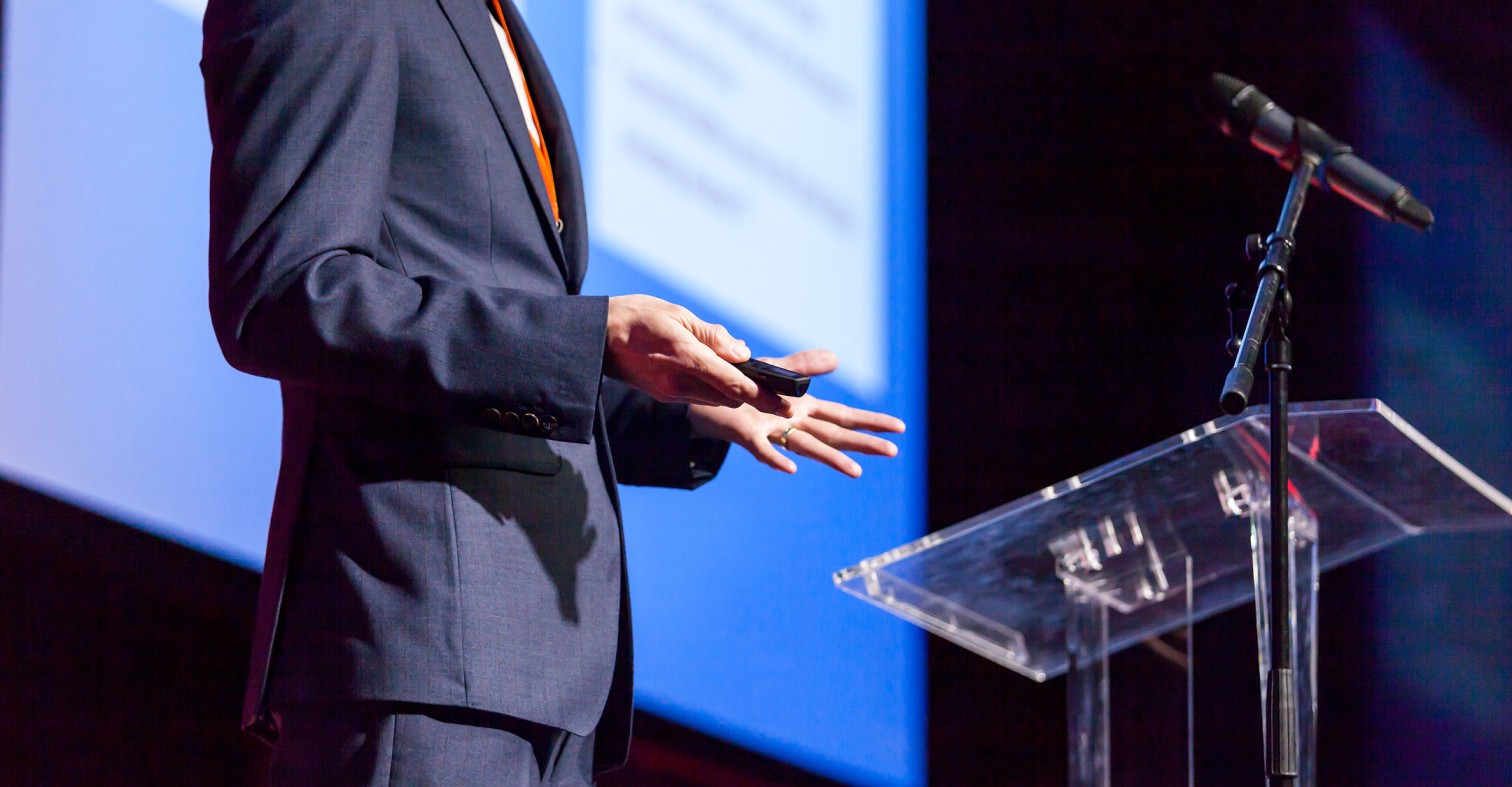 Speaker presenting at a podium